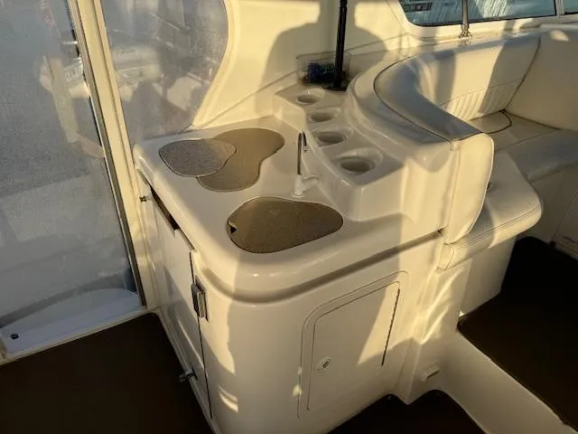 Slide: The Image of 2000 Cruisers Yachts 4450 Express Motor Yacht interior with sink and seating area. - 21