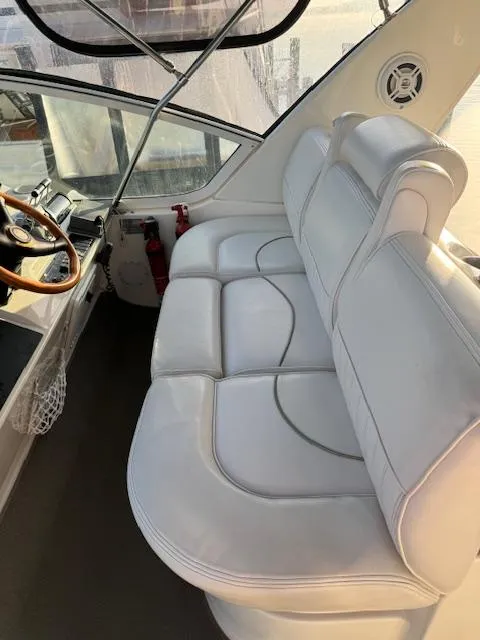 Slide: The Image of 2000 Cruisers Yachts 4450 Express Motor Yacht interior with white leather seating. - 23