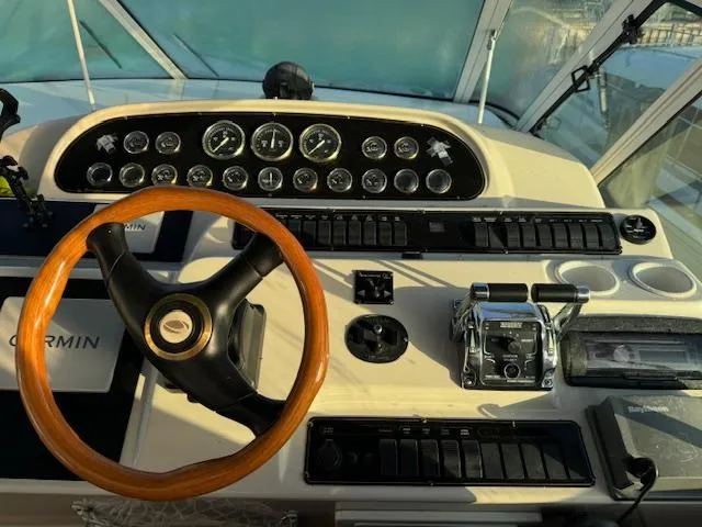 Slide: The Image of Control panel of 2000 Cruisers Yachts 4450 Express Motor Yacht with wooden steering wheel. - 26