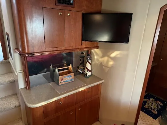 Slide: The Image of Interior of 2000 Cruisers Yachts 4450 Express Motor Yacht with TV and wooden cabinetry. - 31