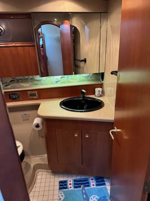 Slide: The Image of Bathroom interior of 2000 Cruisers Yachts 4450 Express Motor Yacht, featuring sink and cabinetry. - 48