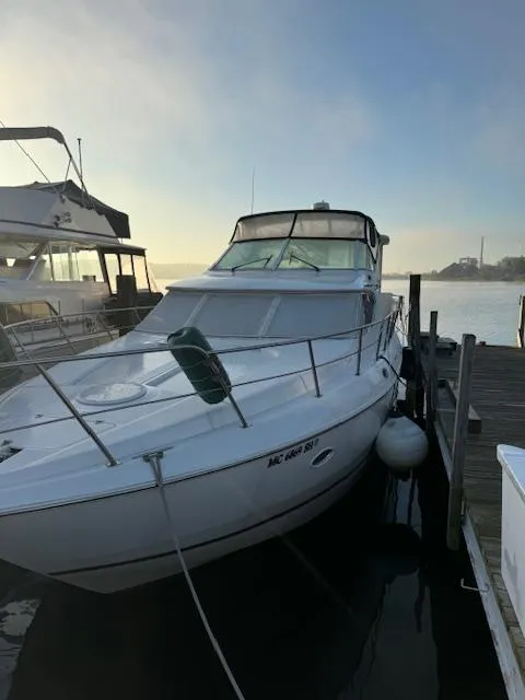 Slide: The Image of 2000 Cruisers Yachts 4450 Express Motor Yacht docked at sunrise. - 12