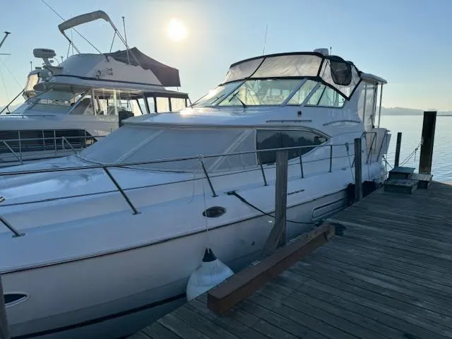 Slide: The Image of 2000 Cruisers Yachts 4450 Express Motor Yacht docked at sunrise. - 13