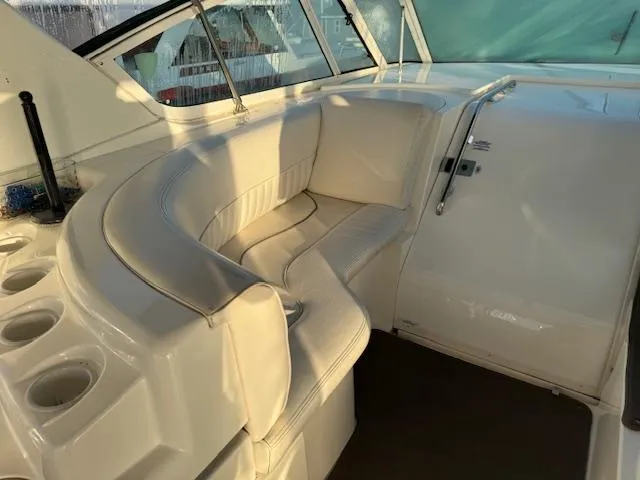 Slide: The Image of 2000 Cruisers Yachts 4450 Express Motor Yacht interior with white seating and cup holders. - 22
