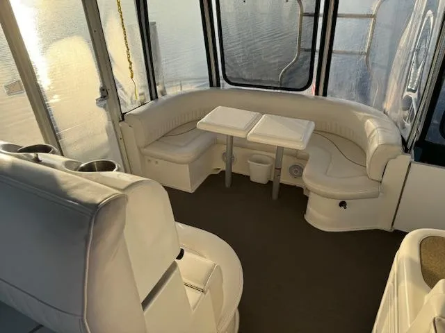 Slide: The Image of 2000 Cruisers Yachts 4450 Express Motor Yacht interior with white seating and tables. - 29