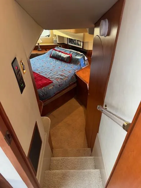 Slide: The Image of Interior of 2000 Cruisers Yachts 4450 Express Motor Yacht bedroom with stairs and cozy bed. - 30