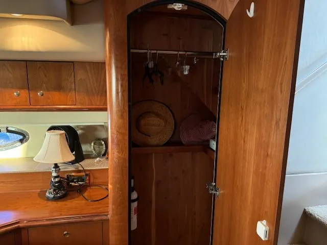 Slide: The Image of Interior of 2000 Cruisers Yachts 4450 Express, featuring wooden cabinetry and a small closet. - 35