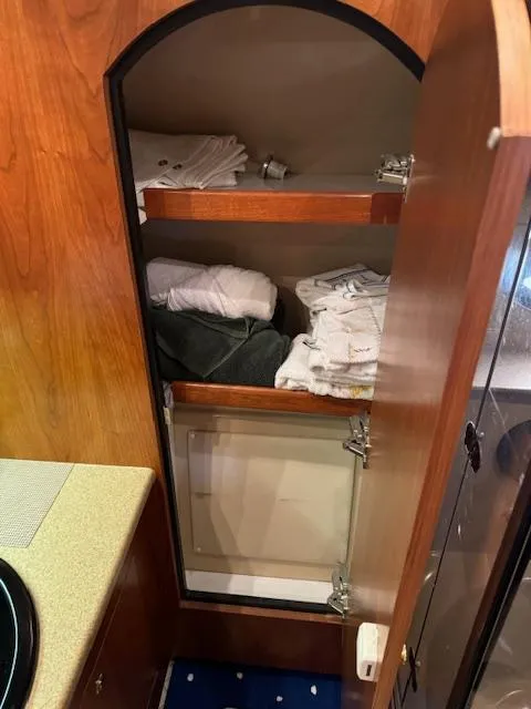 Slide: The Image of Storage cabinet with towels inside a 2000 Cruisers Yachts 4450 Express Motor Yacht. - 38