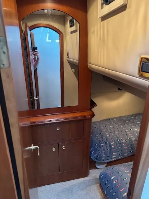 Slide: The Image of Interior cabin of 2000 Cruisers Yachts 4450 Express Motor Yacht with twin beds and wooden cabinetry. - 45