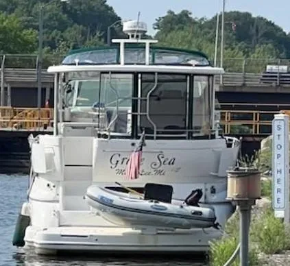 Slide: The Image of 2000 Cruisers Yachts 4450 Express Motor Yacht docked with inflatable boat attached. - 5