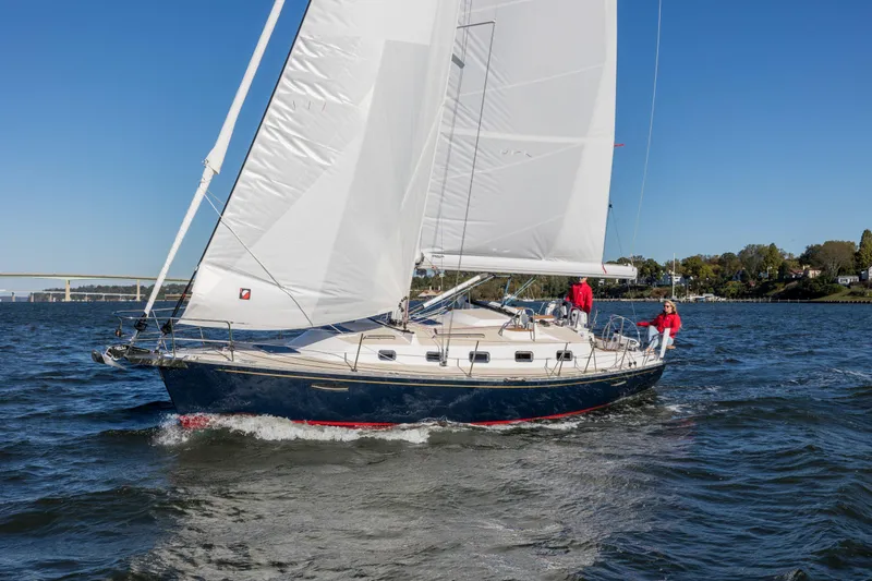 Slide: The Image of Sailing Tartan 365 yacht on open water, 2025 model, with crew in red jackets. - 3