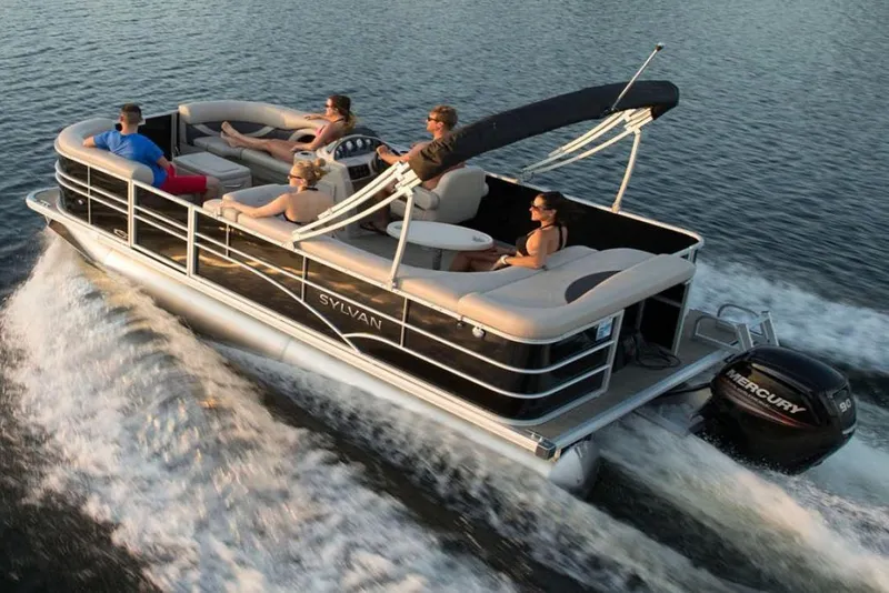 Slide: The Image of 2023 Sylvan 8520 Mirage Cruise pontoon boat on water with passengers enjoying a ride. - 1