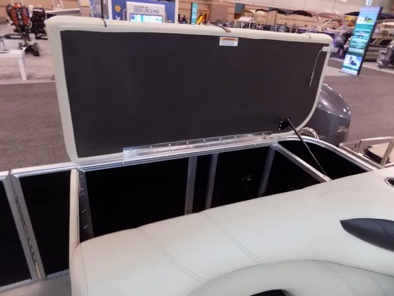Slide: The Image of 2023 Sylvan 8520 Mirage Cruise boat storage compartment open at a showroom. - 11