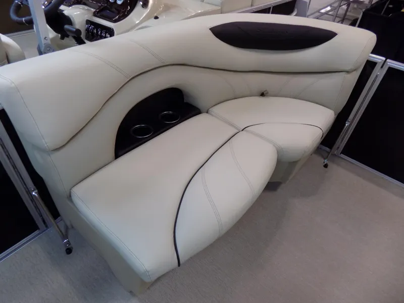 Slide: The Image of 2023 Sylvan 8520 Mirage Cruise boat interior with plush seating and cup holders. - 4