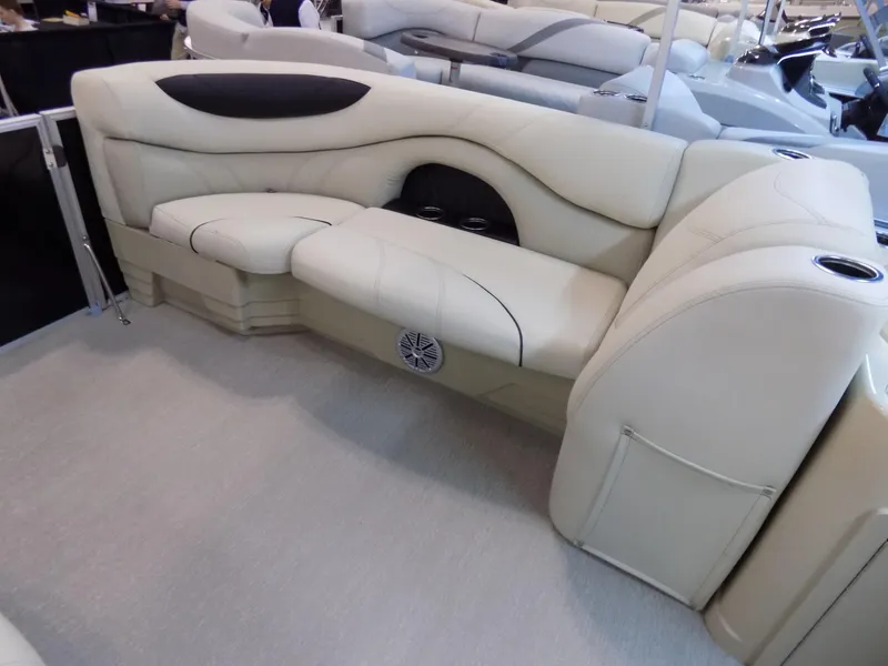 Slide: The Image of 2023 Sylvan 8520 Mirage Cruise boat interior with beige seating and cup holders. - 5