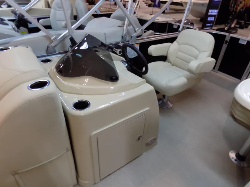 Slide: The Image of 2023 Sylvan 8520 Mirage Cruise boat interior with helm and captain's chair. - 6