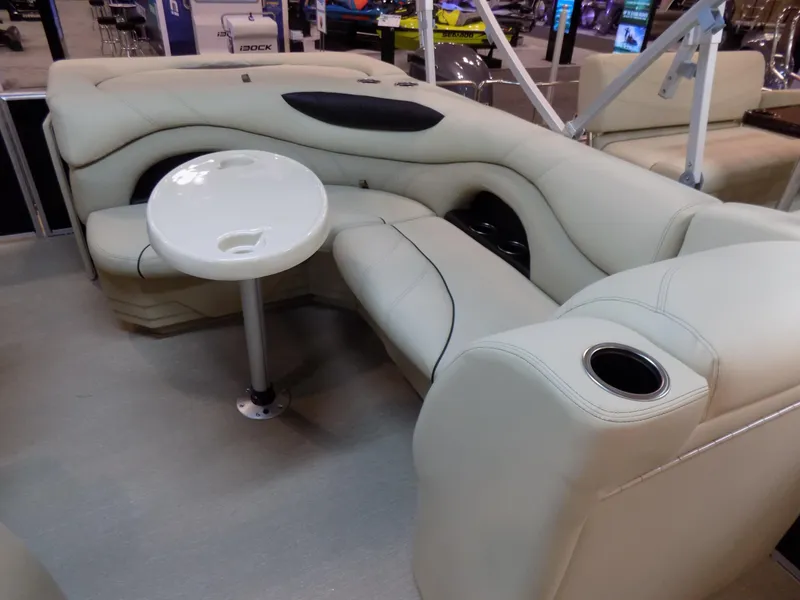 Slide: The Image of 2023 Sylvan 8520 Mirage Cruise interior with beige seating and round table. - 7