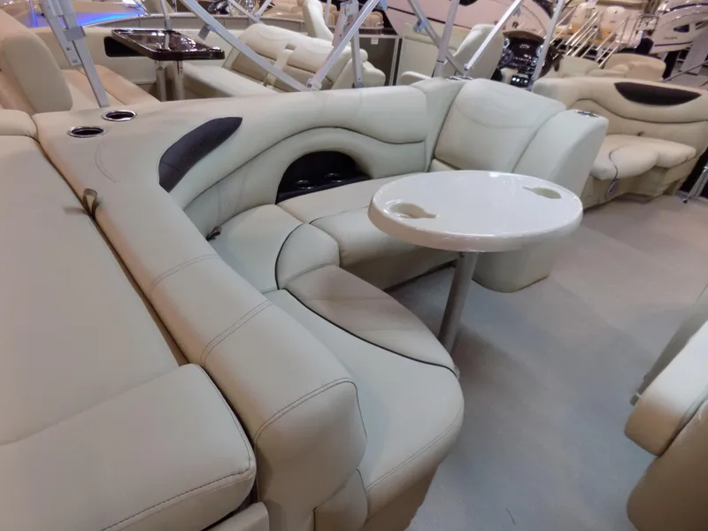Slide: The Image of 2023 Sylvan 8520 Mirage Cruise interior with beige seating and round table. - 9