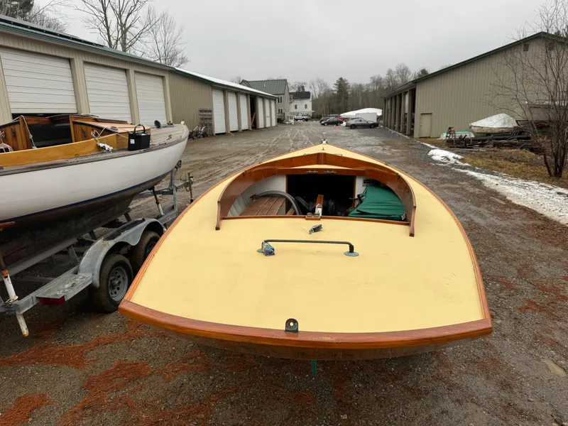 Slide: The Image of 1994 Herreshoff Watch Hill 15 sailboat on trailer, parked near storage buildings. - 16