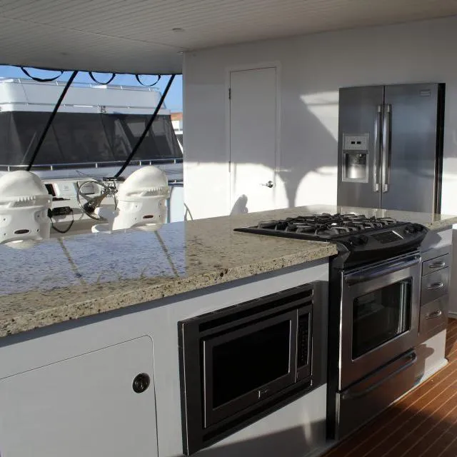 Slide: The Image of Modern kitchen on 2014 Bravada Apollo Trip #1 yacht with granite countertops and stainless steel appliances. - 2