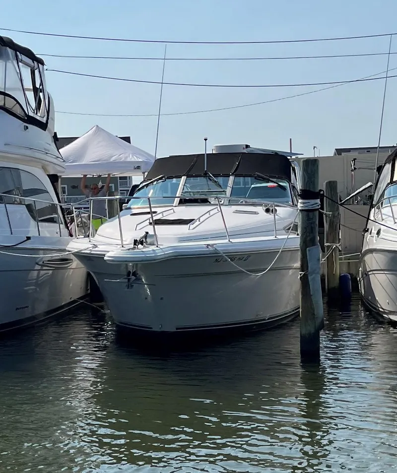 Slide: The Image of 1993 Sea Ray 330 Express Cruiser docked between boats. - 21