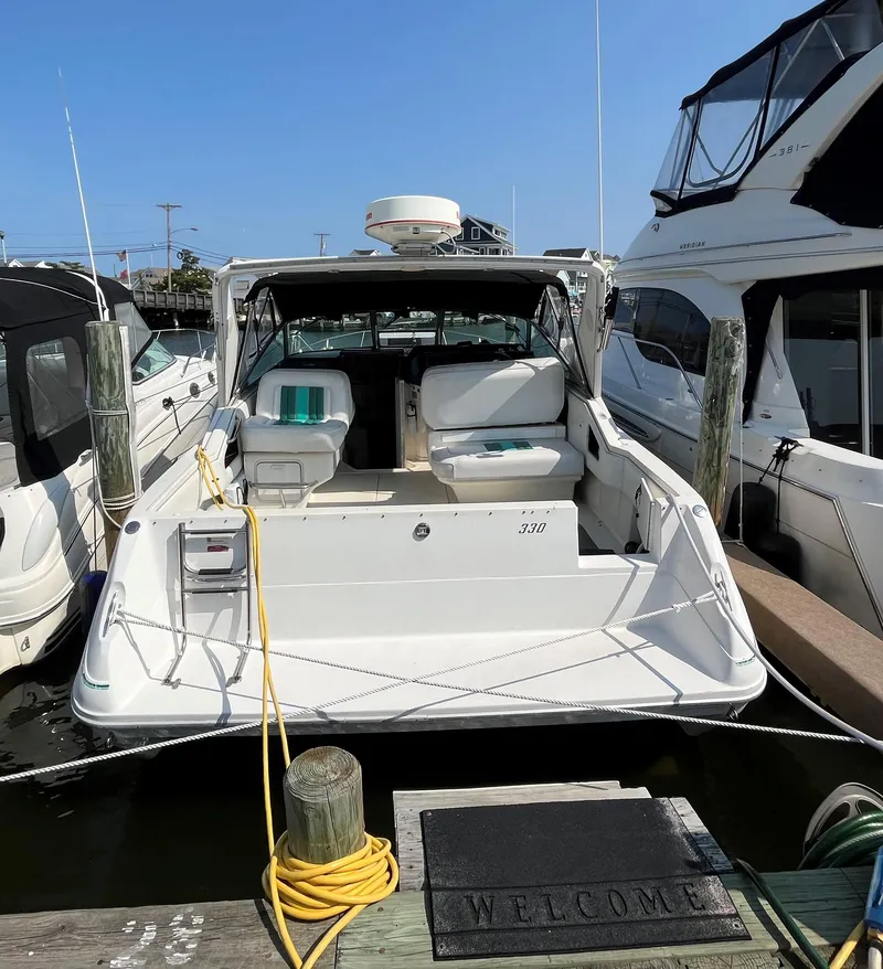 Slide: The Image of 1993 Sea Ray 330 Express Cruiser docked at a marina. - 22