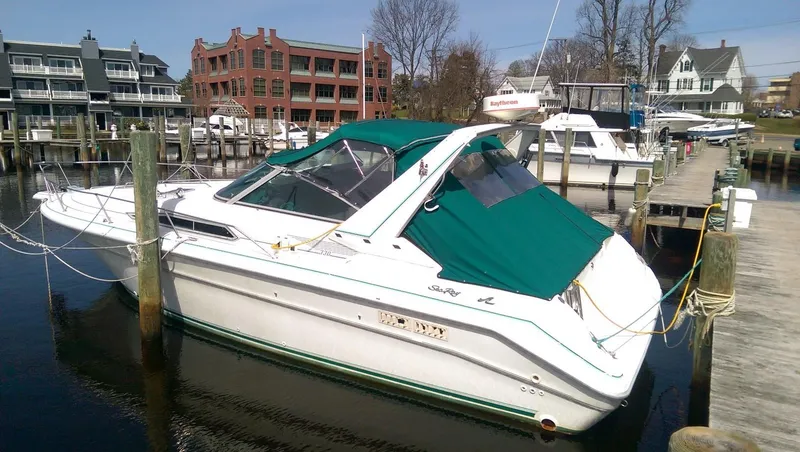 Slide: The Image of 1993 Sea Ray 330 Express Cruiser docked at a marina with green canopy. - 3
