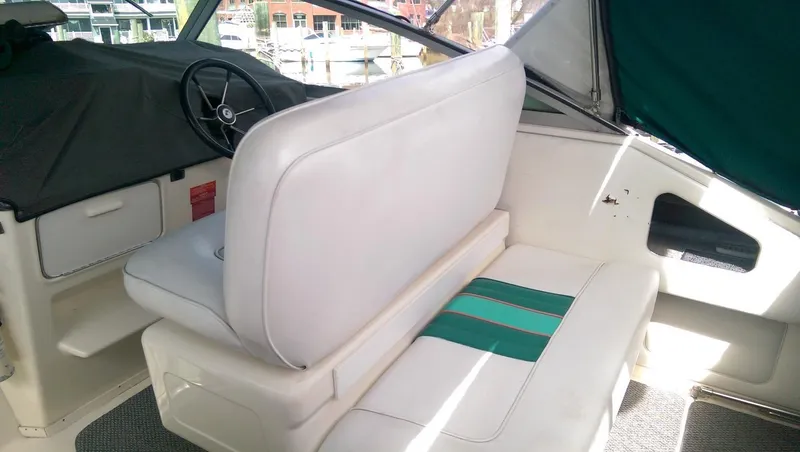 Slide: The Image of 1993 Sea Ray 330 Express Cruiser interior with white seating and green accents. - 7