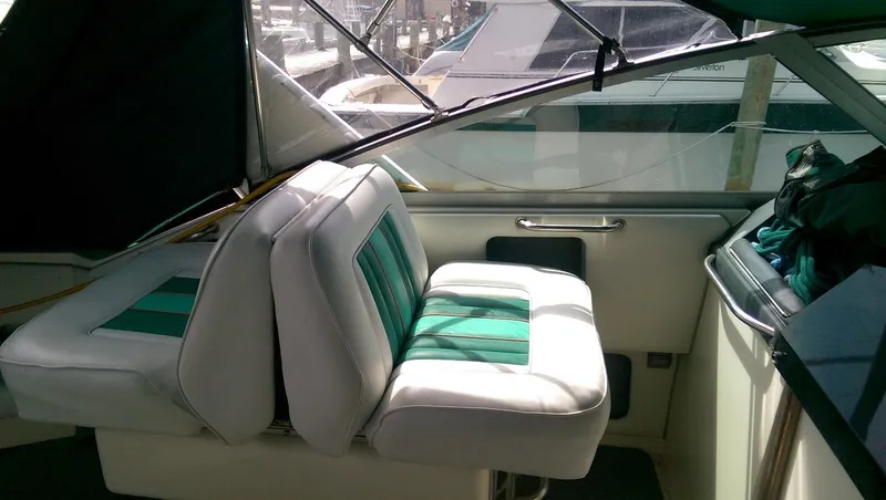 Slide: The Image of Interior of 1993 Sea Ray 330 Express Cruiser with green and white seating. - 8