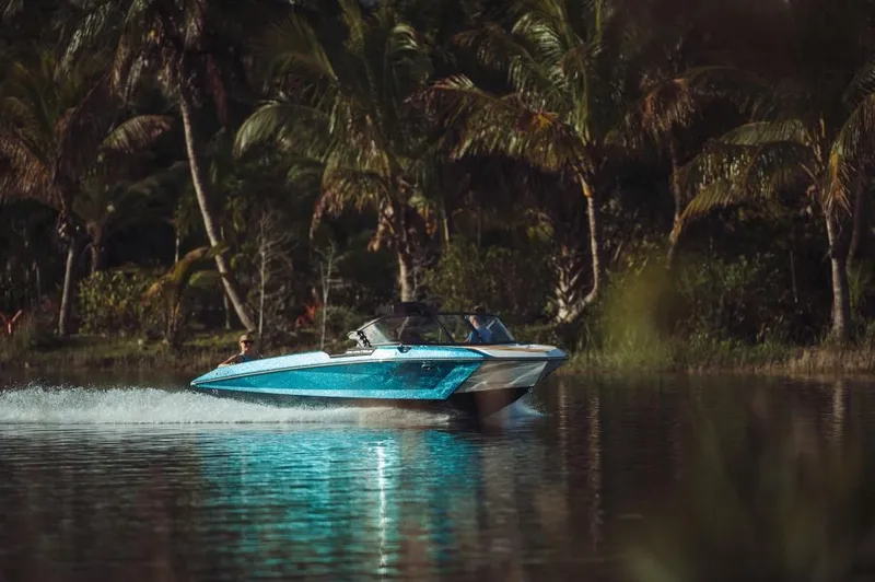 Slide: The Image of 2023 Nautique Ski boat cruising on a tropical lake. - 27