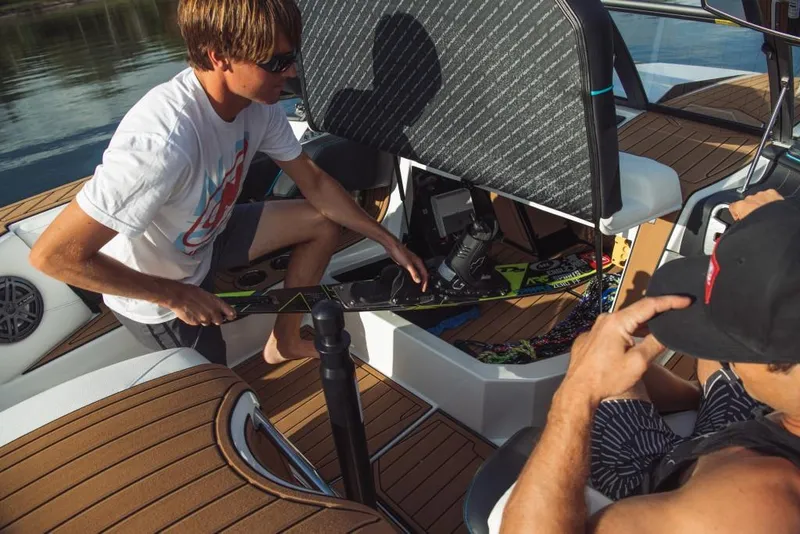 Slide: The Image of 2023 Nautique Ski boat with people preparing water skis on deck. - 40