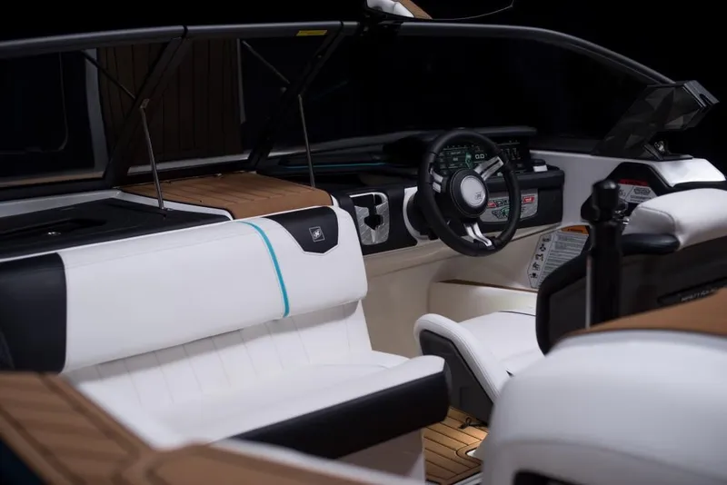 Slide: The Image of 2023 Nautique Ski boat interior with modern dashboard and white seating. - 45