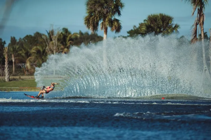 Slide: The Image of Person water skiing behind a 2023 Nautique Ski boat on a sunny day. - 6