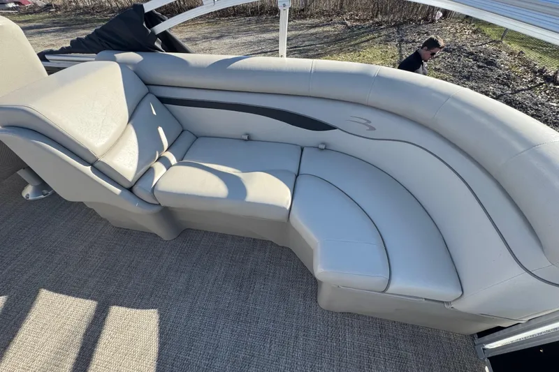 Slide: The Image of 2018 Bennington 22SSRX boat with beige cushioned seating and carpeted floor. - 13