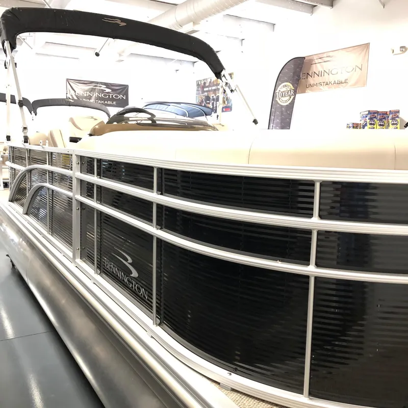 Slide: The Image of 2018 Bennington 22SSRX pontoon boat with Yamaha 150 engine, parked on a trailer. - 2