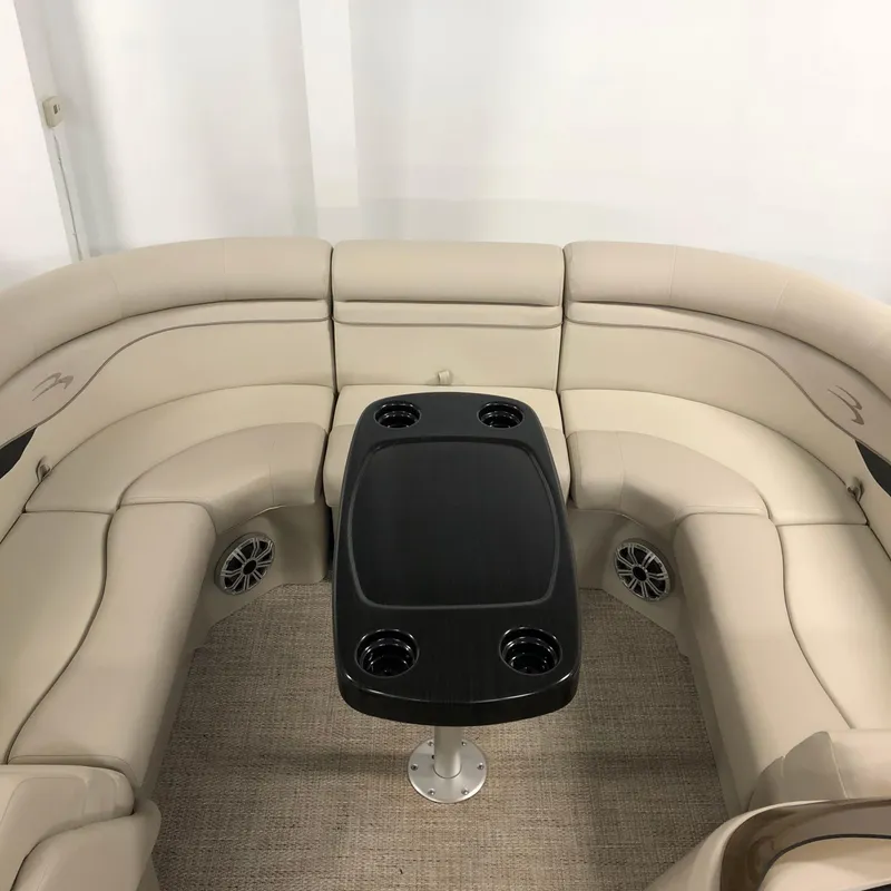 Slide: The Image of Interior of a 2018 Bennington 22SSRX with beige seating and table. - 5