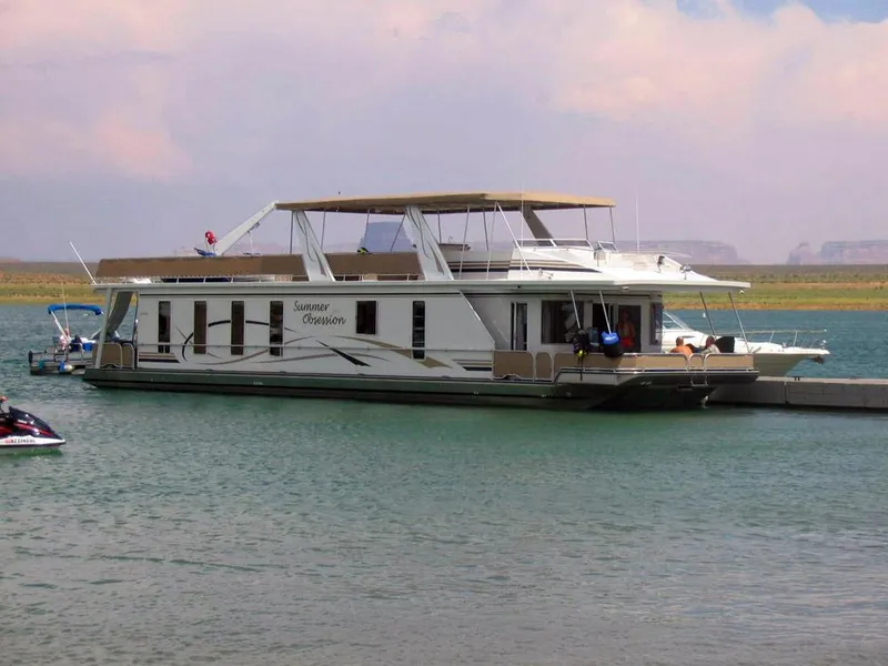The Image of 2005 Stardust Cruisers Summer Obsession Trip 36 houseboat docked on a serene lake. - 0