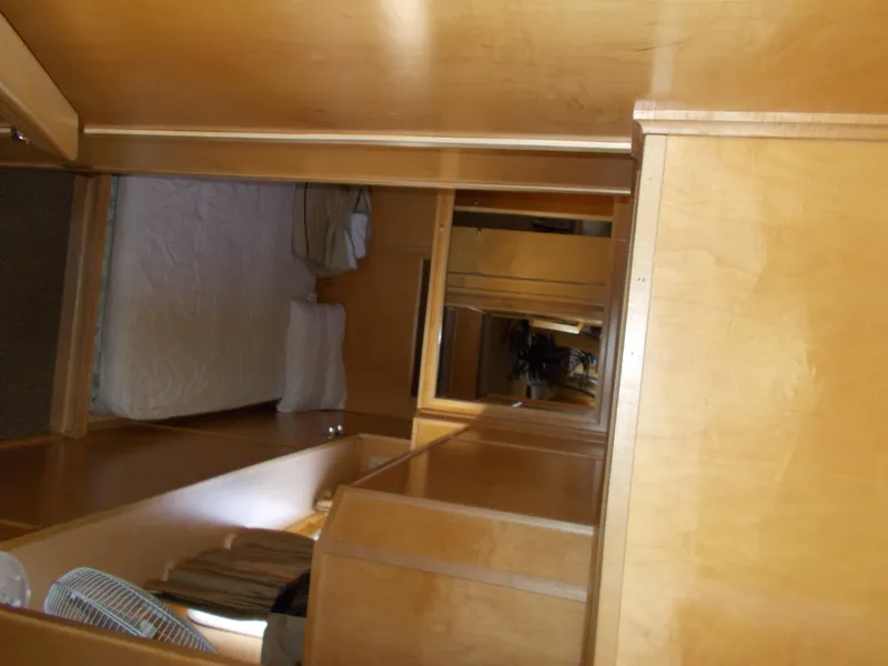 Slide: The Image of Interior of 2005 Stardust Cruisers Summer Obsession Trip 36, featuring wooden cabinetry and a bed. - 17