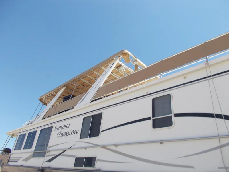 Slide: The Image of 2005 Stardust Cruisers Summer Obsession Trip 36 houseboat under clear blue sky. - 2