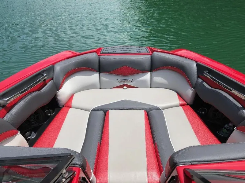 Slide: The Image of 2015 Supra SE 450 boat interior with red and gray seating on a lake. - 10