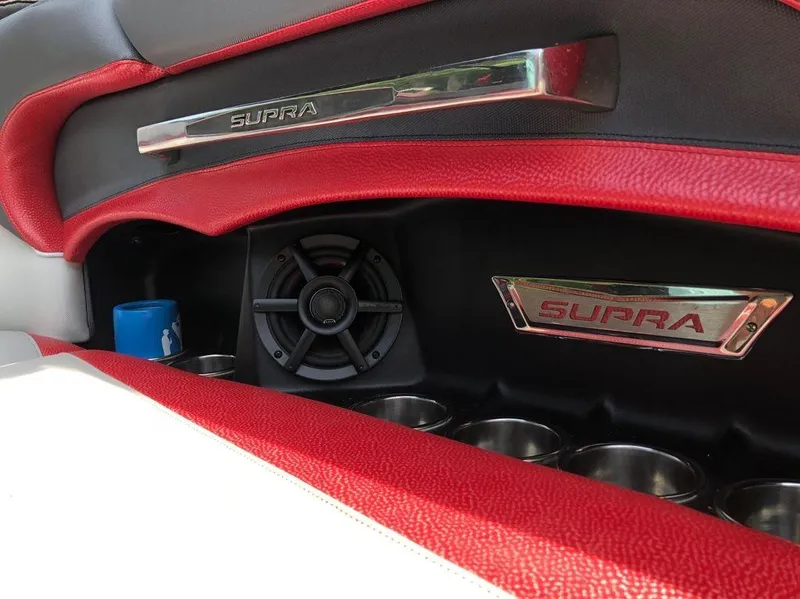 Slide: The Image of Interior of 2015 Supra SE 450 with red accents and speaker system. - 12