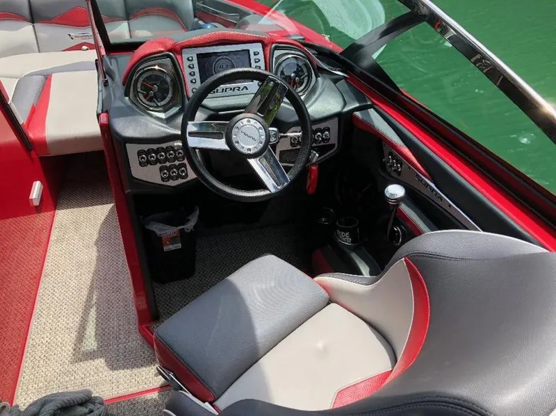 Slide: The Image of Interior of a 2015 Supra SE 450 boat with red and gray accents. - 18