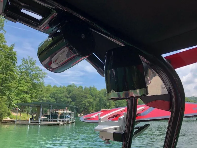 Slide: The Image of 2015 Supra SE 450 boat with speakers on a lake, surrounded by trees and docks. - 19