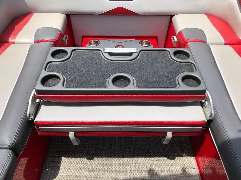 Slide: The Image of 2015 Supra SE 450 boat interior with red and gray seating and cup holders. - 20
