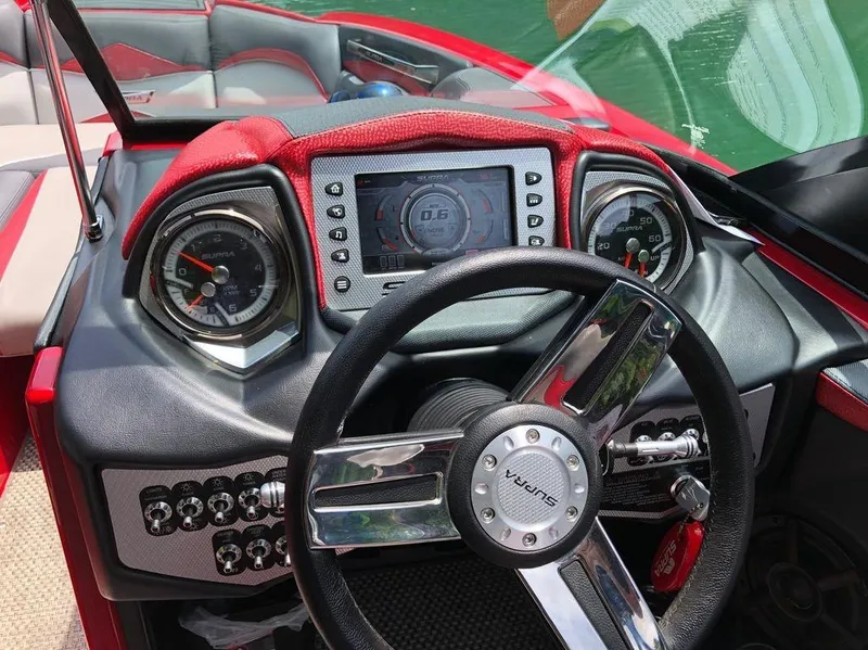 Slide: The Image of Dashboard of a 2015 Supra SE 450 boat with steering wheel and gauges. - 4