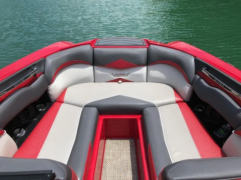 Slide: The Image of Red and gray interior of 2015 Supra SE 450 boat on water. - 9