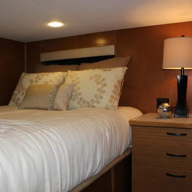 Slide: The Image of Cozy bedroom in 2014 Bravada Infinity Trip #1 with elegant bedding and bedside lamp. - 13