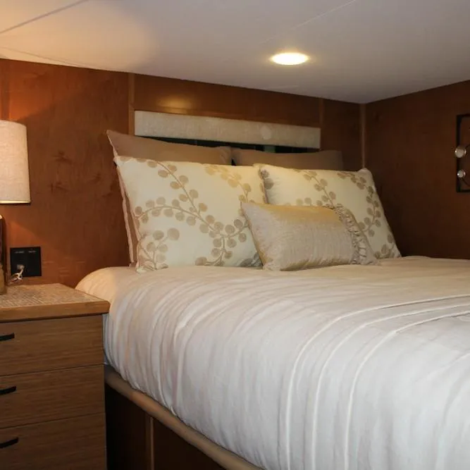 Slide: The Image of Cozy bedroom in 2014 Bravada Infinity Trip #1 houseboat with wooden walls and soft lighting. - 14