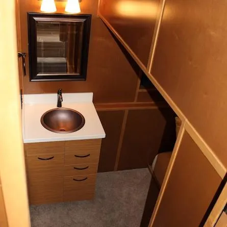 Slide: The Image of Compact bathroom in 2014 Bravada Infinity Trip #1 houseboat with sink, mirror, and wooden cabinetry. - 17