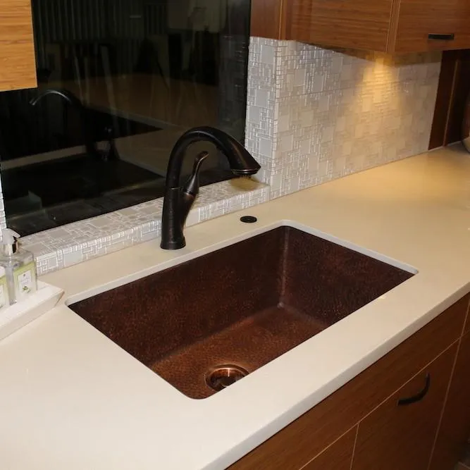 Slide: The Image of Modern kitchen sink with bronze faucet, white countertop, and mosaic tile backsplash. Bravada Infinity Trip #1, 2014. - 6